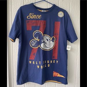 New NWT Disney Parks Reversible Blue and Yellow T-shirt in a size Medium